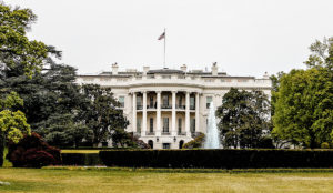 a white house with a flag on top with White House in the background