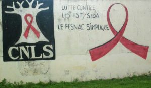 a wall with a red ribbon and a sign