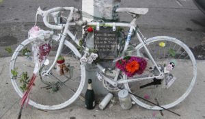 "Ghost bike" memorial with flowers and candles
