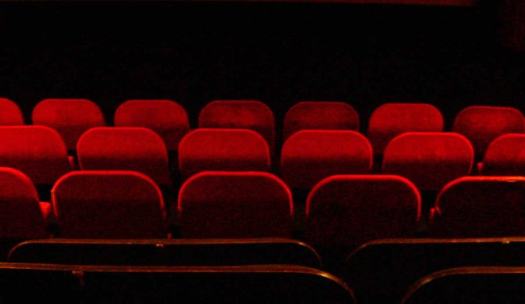 Red velvet seats inside a movie theater