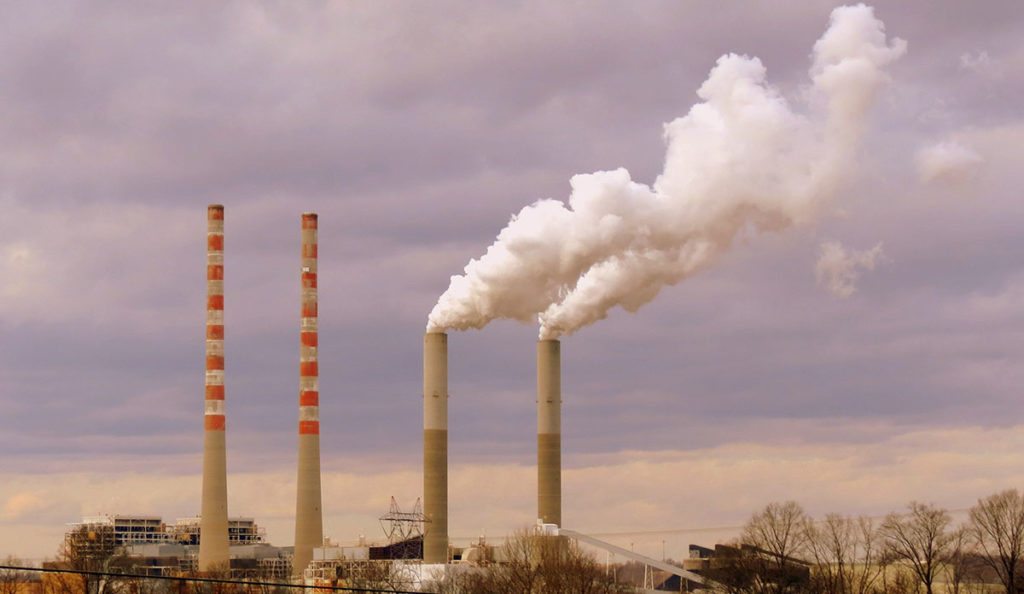smoke stacks of smoke coming out of a factory