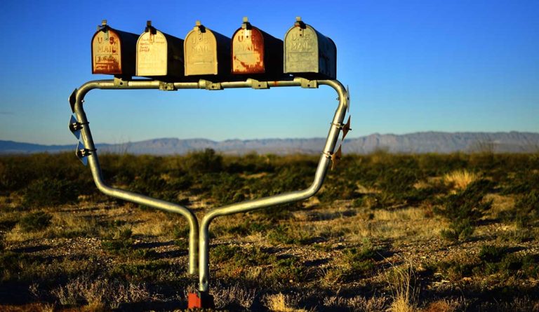 a group of mailboxes in a field