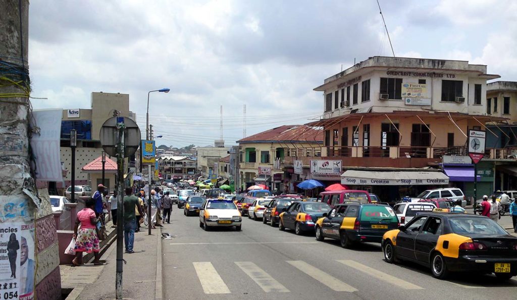 a busy street with cars and people