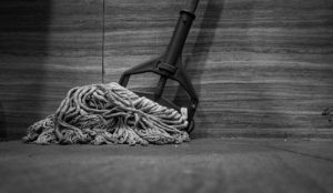 A black and white photo of a mop