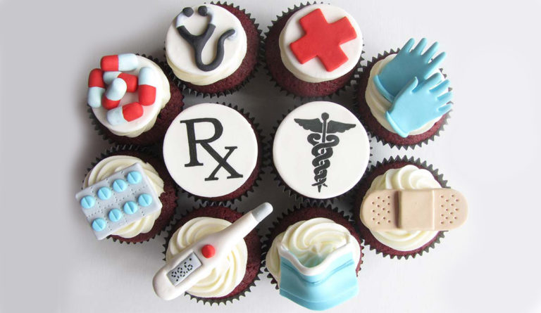 a group of cupcakes with medical symbols