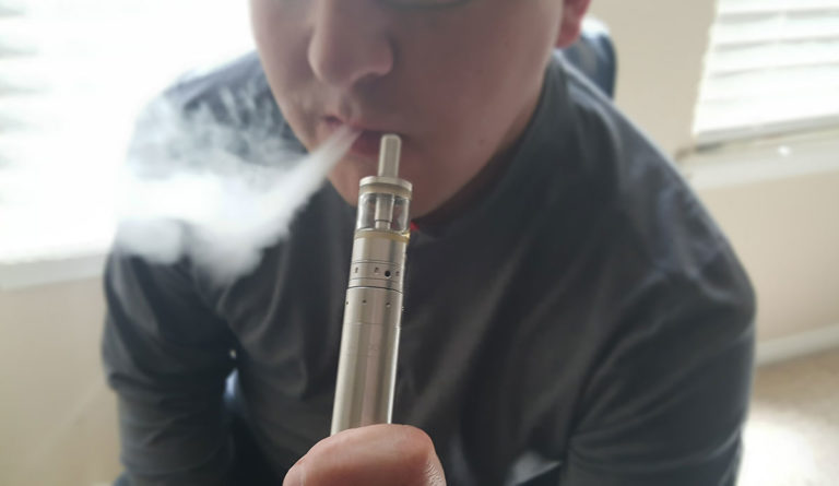 a person smoking a vaporizer