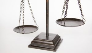 a balance scale with a chain