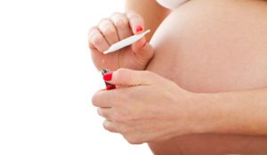 a pregnant woman holding a lighter