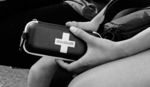 a person holding a first aid kit