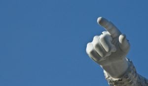 a statue of a hand pointing at something