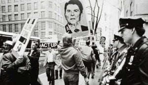 New York, NY: May 5, 1988. Watched by a line of police, ACT UP stages a demonstration. © Lee Snider/The Image Works