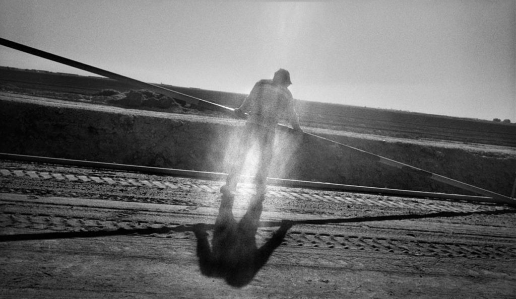 a man standing on a dirt road