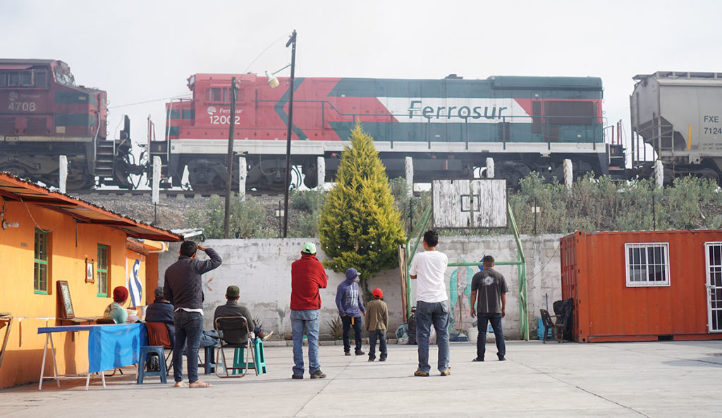 a group of people standing in front of a train