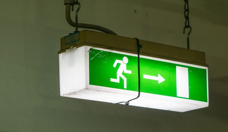a green sign with a person running on it
