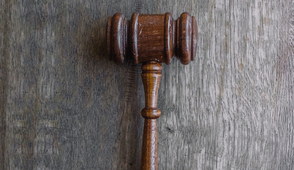 a wooden gavel on a wood surface