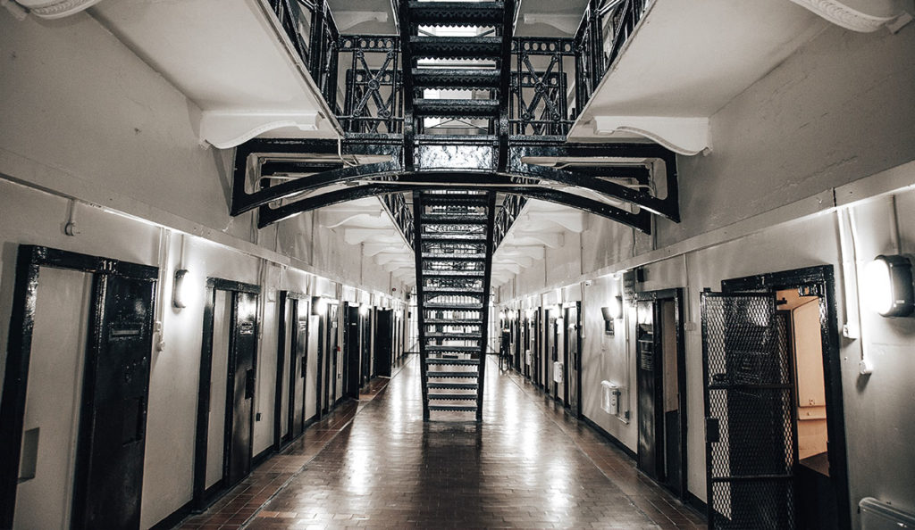 a long hallway with a staircase and doors
