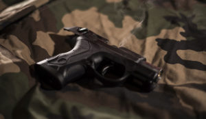 a gun on a camouflage cloth