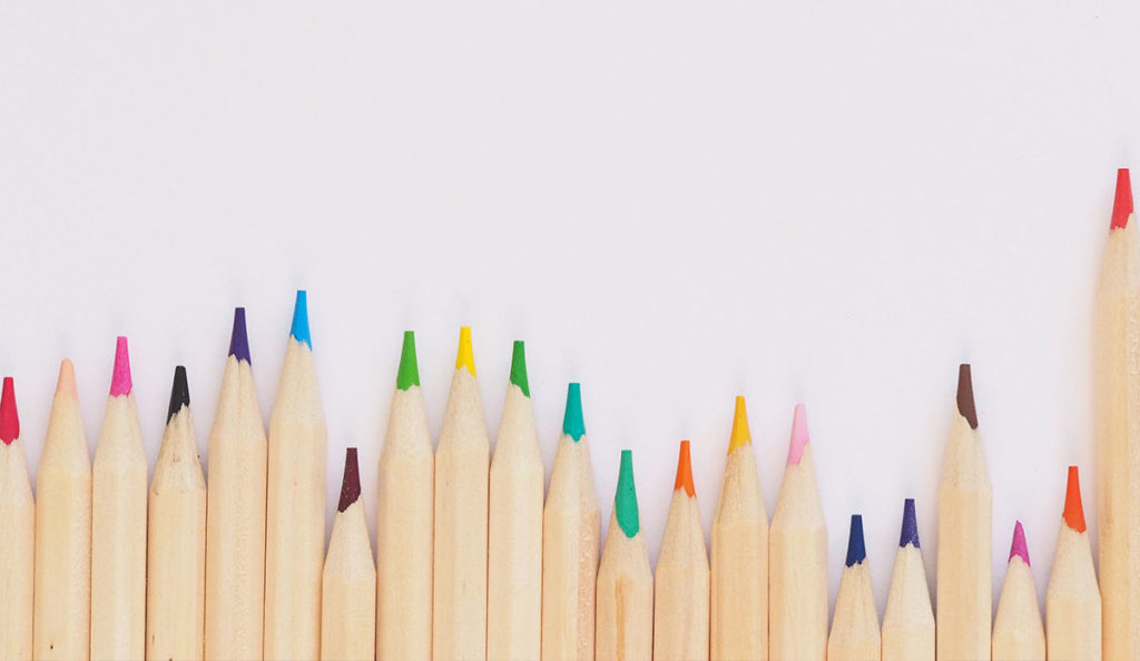 a row of colored pencils