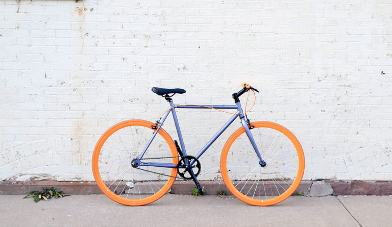 a bicycle with orange wheels