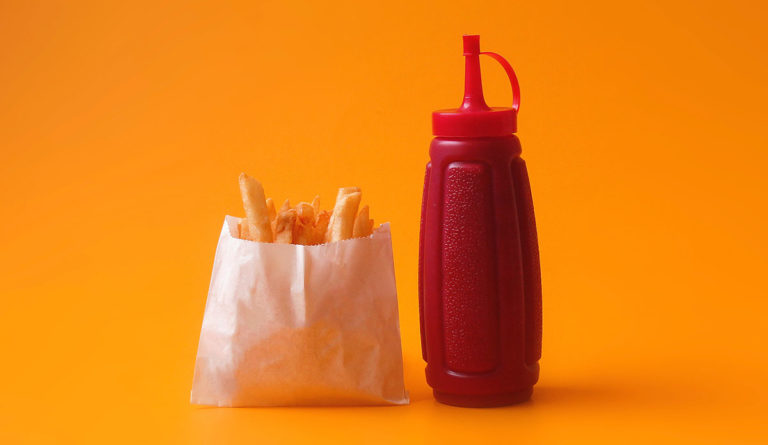 a bottle of ketchup and french fries