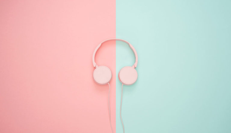 a pink headphones on a pink and blue background