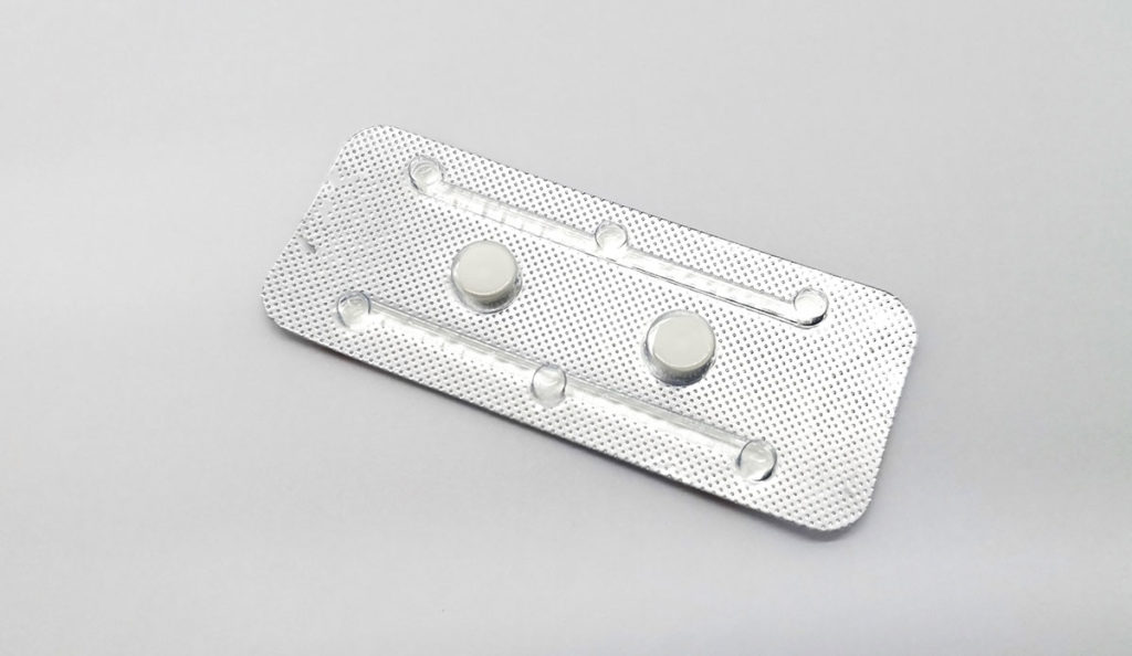 a white pills in a silver package