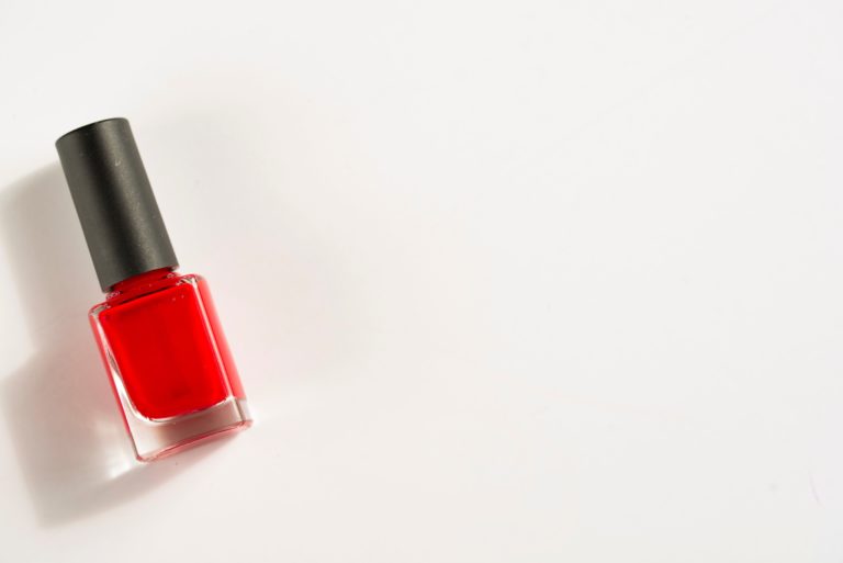 a bottle of red nail polish