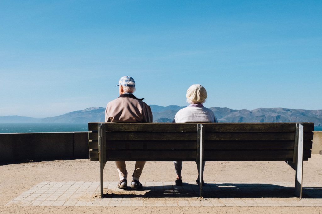 a man and woman sitting on a bench