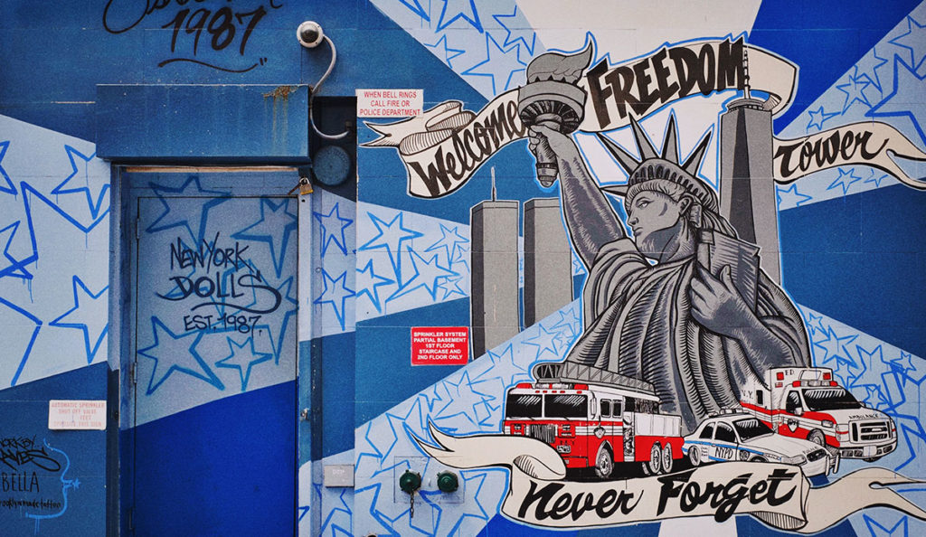 a blue and white wall with graffiti