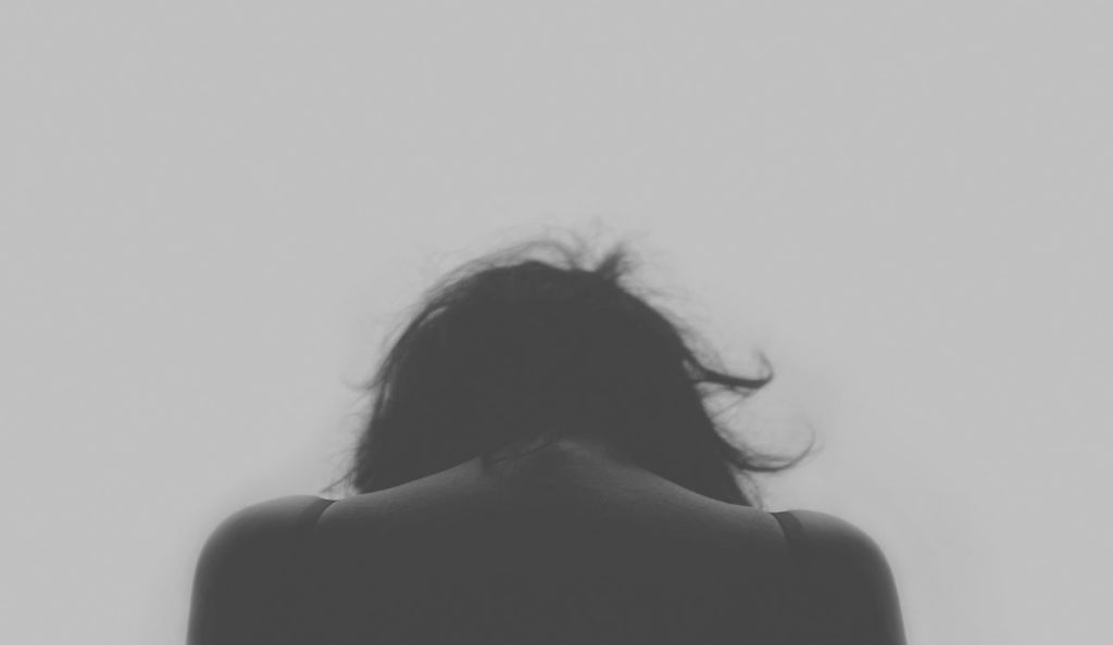 a back of a person with their hair blowing