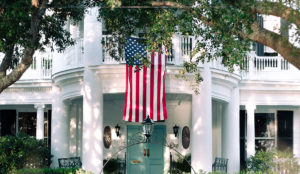 a flag from a balcony of a house