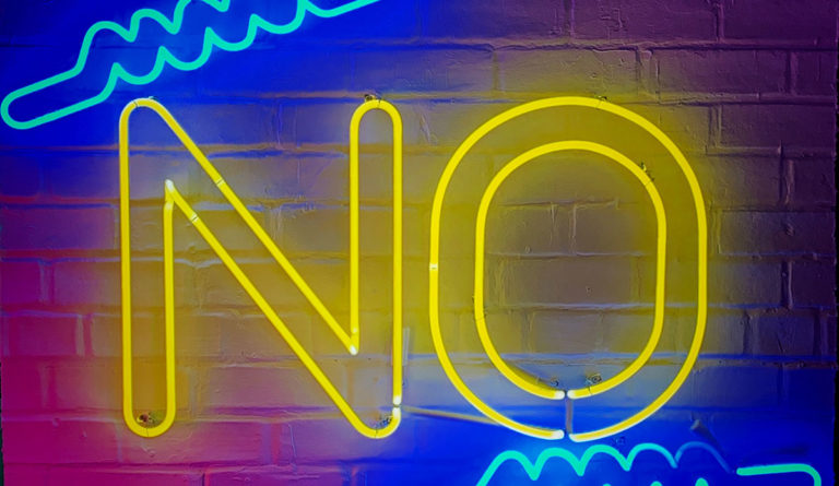 a neon sign on a brick wall