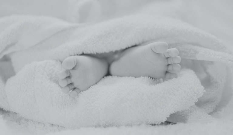 a baby feet under a blanket
