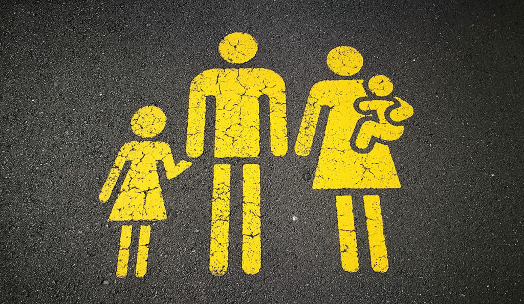 a yellow painted sign on the ground