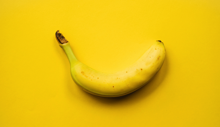 a banana on a yellow background