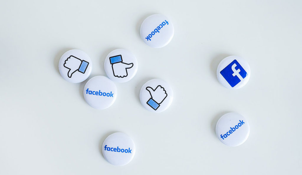a group of buttons with logos on them