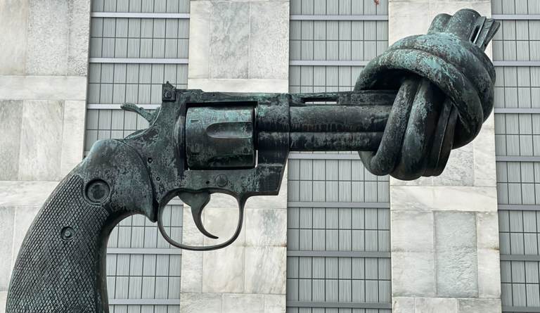 a gun with a knot on a statue