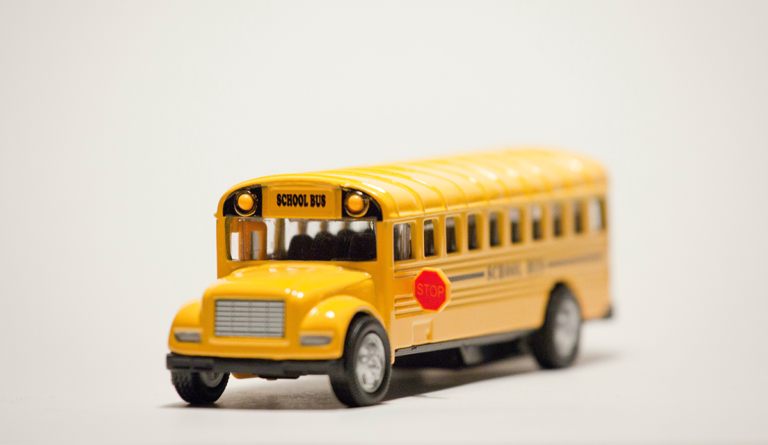 a yellow school bus with a stop sign