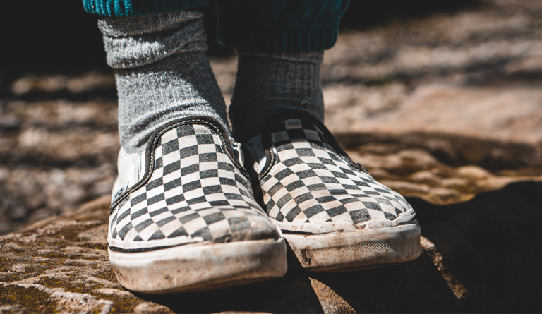 a person wearing checkered shoes