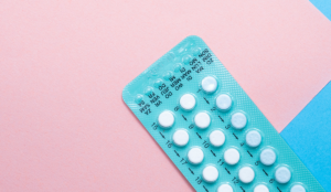 a pack of pills on a pink background