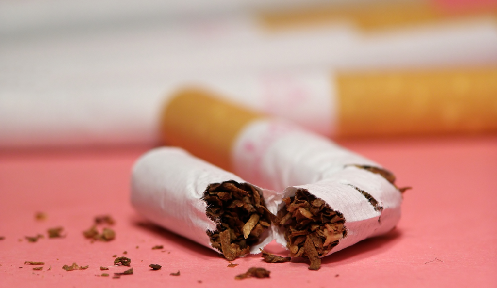 a broken cigarette with brown tobacco