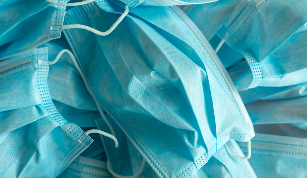 a pile of blue medical masks