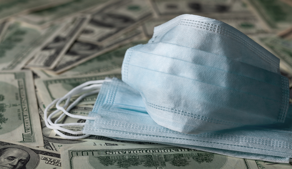 a face mask on top of money