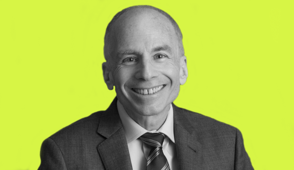 a man in a suit smiling
