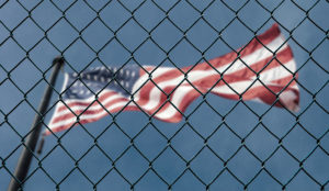 a flag behind a fence