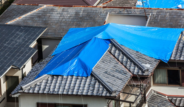 a blue tarp on a roof