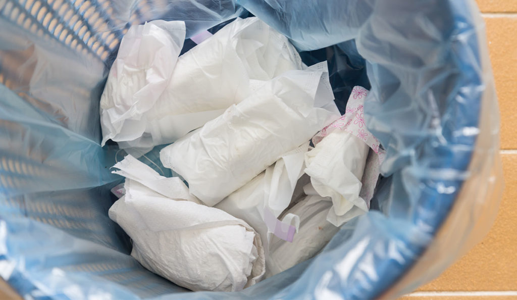 a trash can full of white paper towels