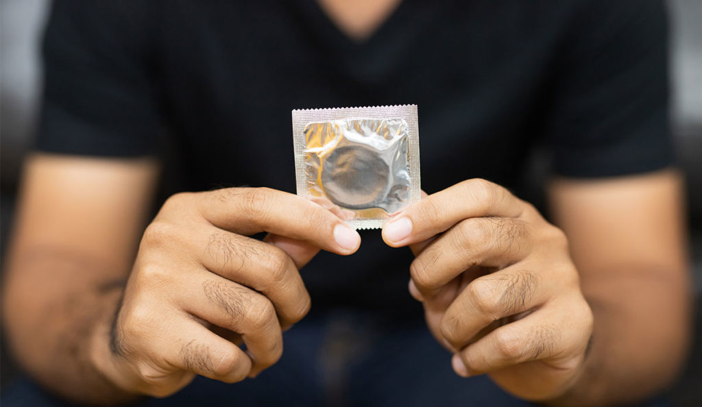 a person holding a condom