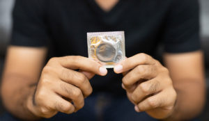 a person holding a condom