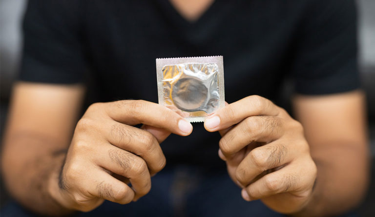a person holding a condom